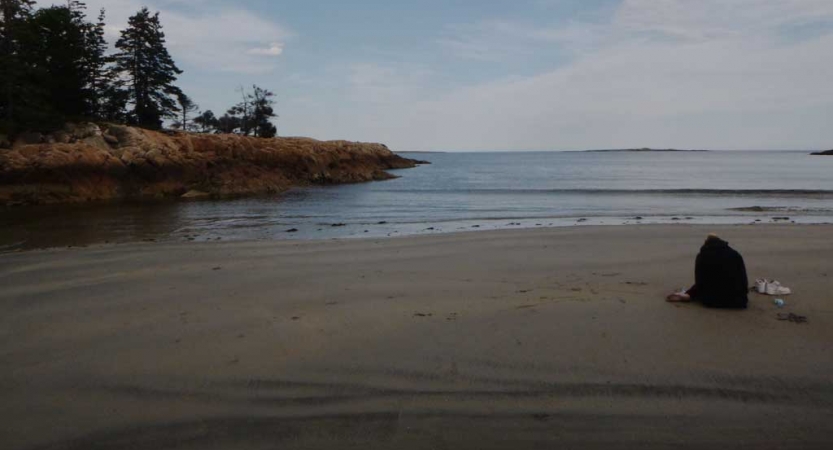 an empty beach with mostly calm waters